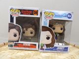 two pop vinyl figures of the same character in the box