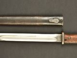 two knives that are laying side by side on a table