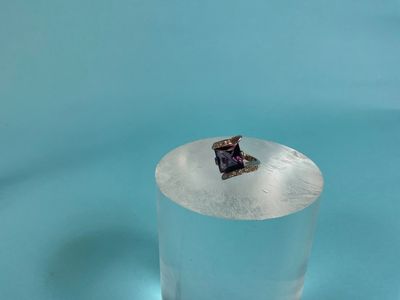 a small piece of ice in the middle of a glass