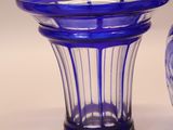 two blue vases sitting next to each other on a table