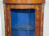 a wooden cabinet with a blue glass door in it