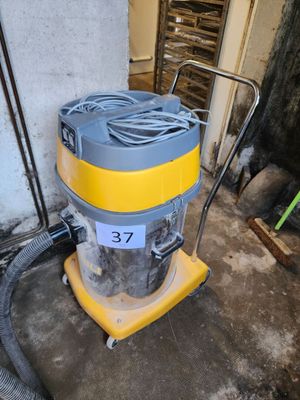 a yellow and gray vacuum sitting in a room