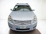 a silver car that is parked in a white room