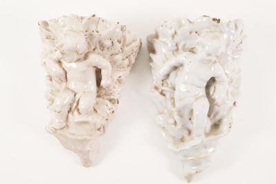 pair of white ceramic angel wall sconces on a white background