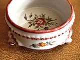 a small bowl with a flower design on it