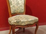 a chair that is sitting in front of a red wall