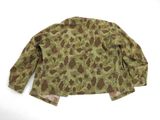 a close up of a camouflage jacket on a white surface