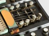 a close up of a guitar case with many knobs on it
