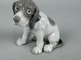 grey and white dog figurine sitting next to a black and white dog