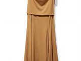 the dress is hanging on a hanger on a white wall