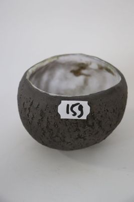 a small bowl with a sticker on it on a table