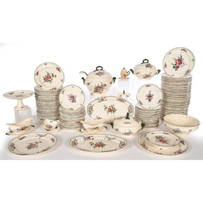 a lot of plates and bowls that are sitting on a table