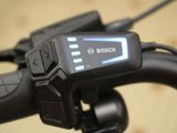 a close up of a bicycle handlebar with a clock on it