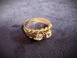 a close up of a gold ring on a black surface
