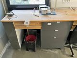a desk that has a lamp on top of it