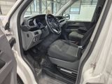 the interior of a white truck with the door open and the driver ' s seat down