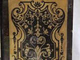 a black and gold book sitting on top of a table