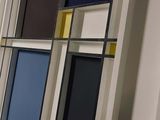 many different colored frames on the wall in this room