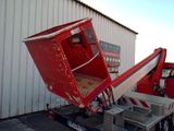 a red and white truck with a red and white container on the back