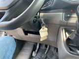 a car dashboard with a keychain attached to the steering wheel