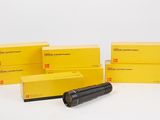 a group of yellow boxes and a black pipe on a white surface