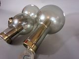 two silver and gold wine bottles on a white table