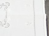 a white table cloth with a picture of a cat on it