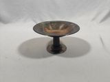 a small metal bowl on a stand on a white background