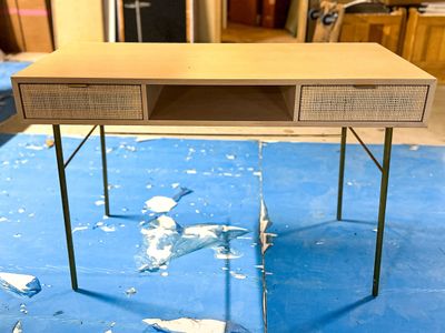 a desk with a drawer on top of it on a blue rug