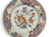 a plate with a floral design on it on a white surface
