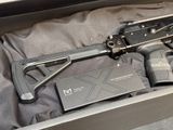 a gun that is in a box on a bed