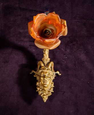 an image of a candle holder with a flower on it