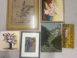 many paintings on the wall above a vase of flowers