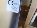a metal box with a sign on it in a kitchen