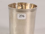 a silver cup with a number on it sitting on a table
