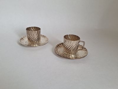pair of silver plated tea cups and saucers