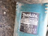 a close up of a blue motor bike with a sticker on it
