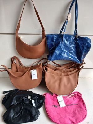 four different purses are lined up on a white surface