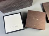 three gucci boxes are sitting next to each other on a table