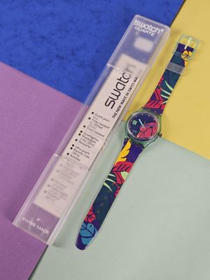 a watch that is sitting on a colorful surface