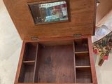 a wooden box with a mirror inside of it