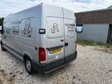 a van that is parked in a lot near a building