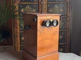 a small wooden box with two knobs on top of a table