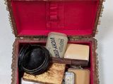 a small wooden box with a hat and other items in it