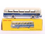 a blue and white toy bus sitting on top of a yellow box