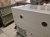 a white box sitting on top of a cart in the middle of a room