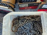 a plastic container filled with a rock next to a pair of chains