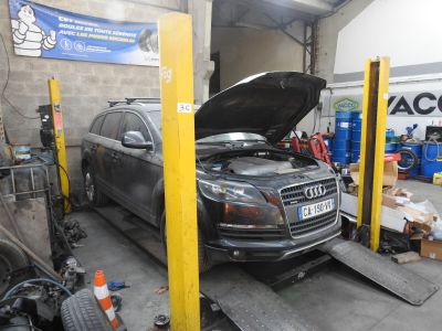a car that is sitting on a lift in a garage
