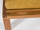 a wooden bench with a yellow cushion on top of it