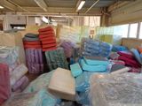 a large amount of plastic bags and blankets in a warehouse